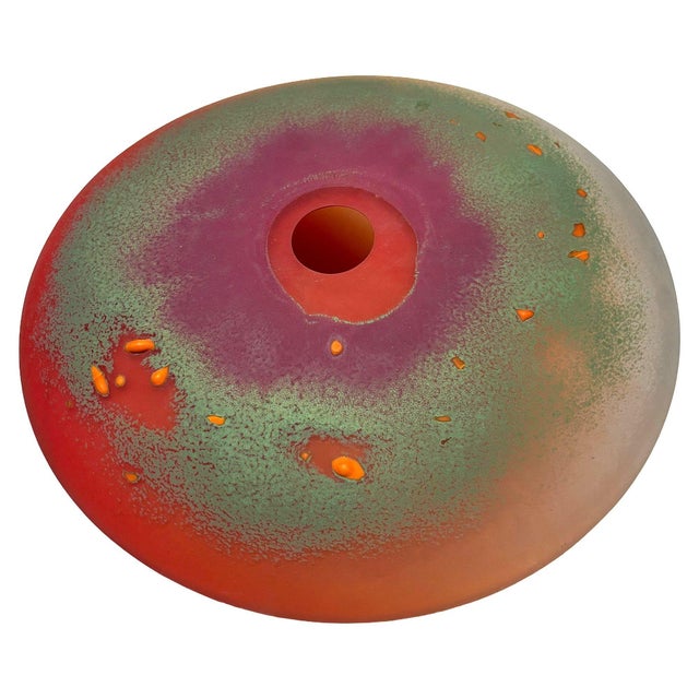 This striking 1985 Post-Modern art glass vase, signed by Steve Hourigan, features a flattened disc form with a central...