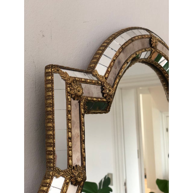 Vintage Venetian beveled large cartouche mirror in Spanish style, dating from the 1990s. The handcrafted smoked glass...