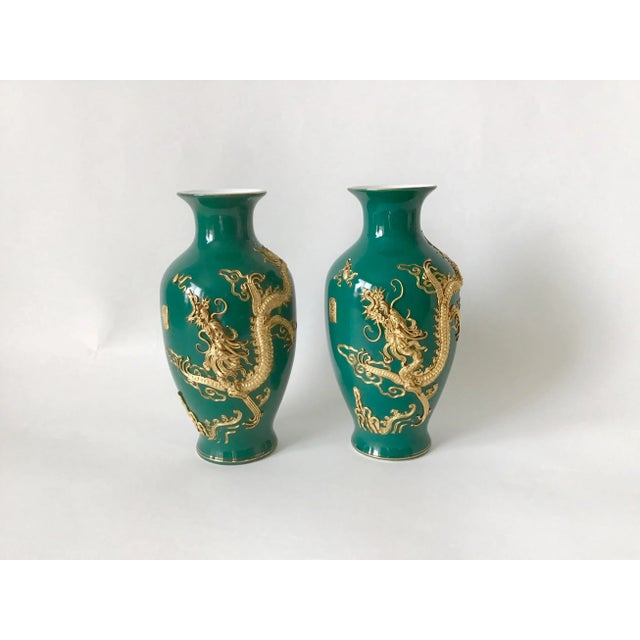 Set of two green Chinese vintage porcelain vases, with gold good luck symbol of golden dragons. Front side dragon design,...