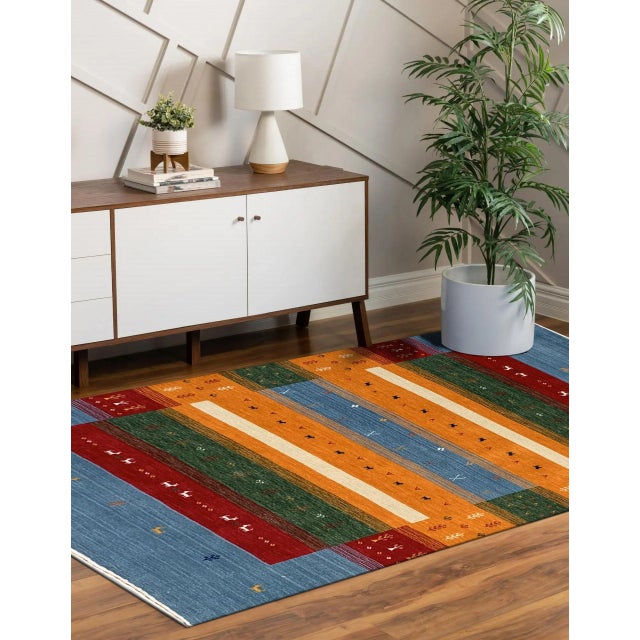 Timeless Gabbeh Blue Handmade Wool Rug, Country of Origin: India. This exceptional piece blends the robust structure of...