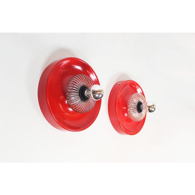 A unique and uncommon set of wall lamps by the hungarian manufacturer elektrofém. These feature lacquered metal disc...