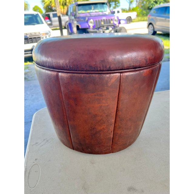 Vintage mid-century modern round vinyl footstool or pouf. Segmented vertical paneled stitch detailing and rich brown hue...