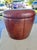 Vintage mid-century modern round vinyl footstool or pouf. Segmented vertical paneled stitch detailing and rich brown hue...