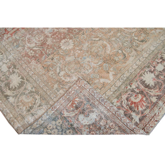 Beautiful Antique Mahal hand-knotted wool rug with a red field. This rug has a brown frame and multi-color accents in a...
