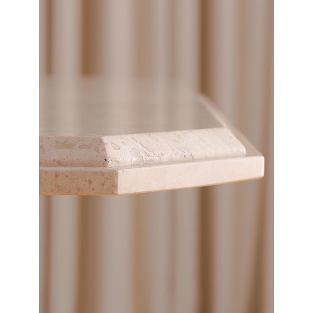 A striking vintage square dining table crafted entirely from solid travertine. This piece features a substantial...