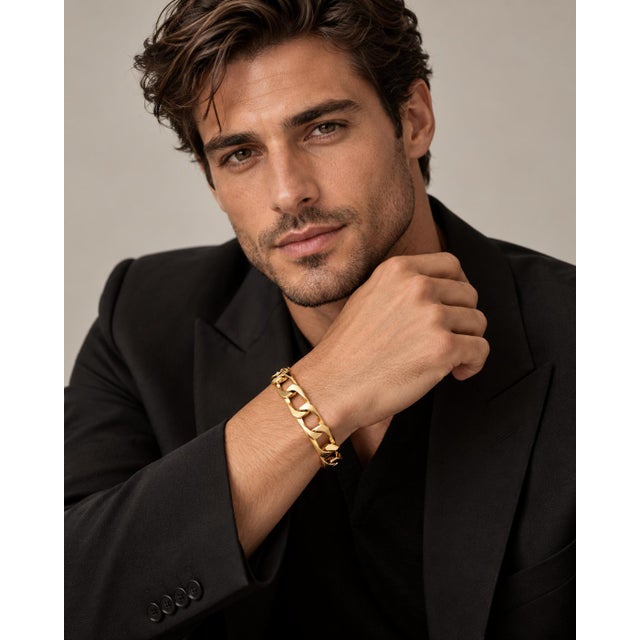 A statement of bold confidence and enduring strength, this hefty curb chain bracelet wraps the wrist in the warm,...
