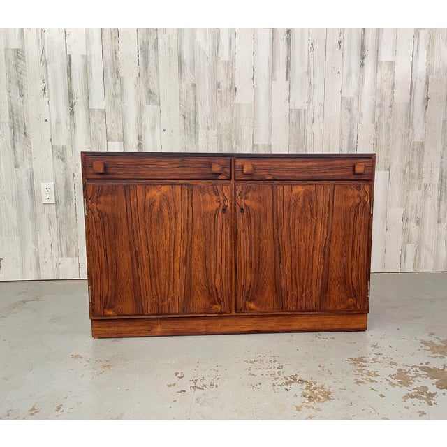 Petit rosewood Danish Modern cabinet with two drawers over two doors perfect for entry way. Creator: O. Bank Larsen...