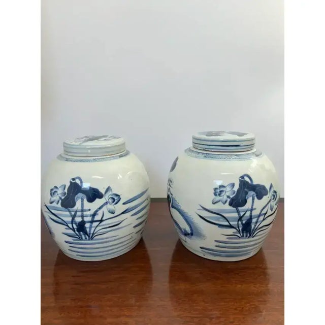 This is a rare pair of beautiful vintage 8 inch lidded ginger jars with a coastal motif of cranes, water and shore grass....