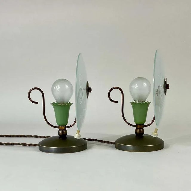 These elegant table lamps were designed any manufactured in Italy in the 1950s. The lights feature circular frosted glass...