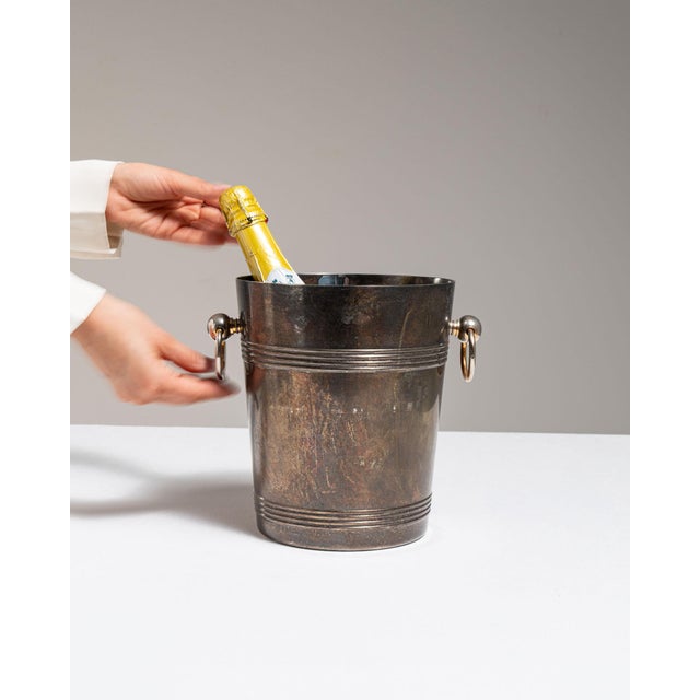 This mid 20th century ice bucket from France is finished in silver. Its form follows honest, well-proportioned lines...