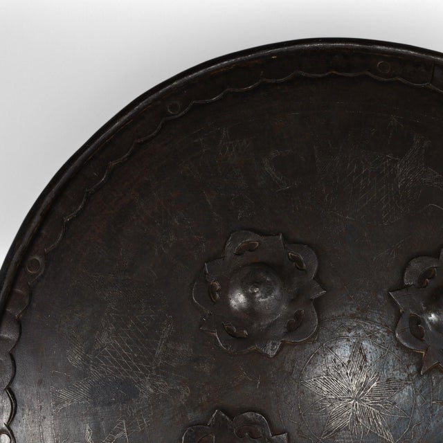 Intriguing historical 19th Century Indo Persian shield handcrafted in steel and decorated with four floral protuberances...