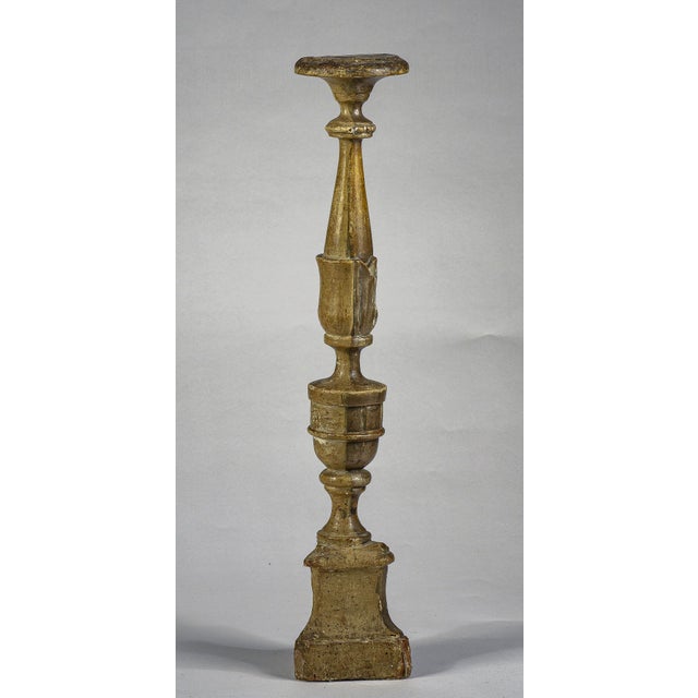 This is a gold and silver lacquered wooden candlestick holder by Bolo Italia from late 1700s. It has a triangular base...