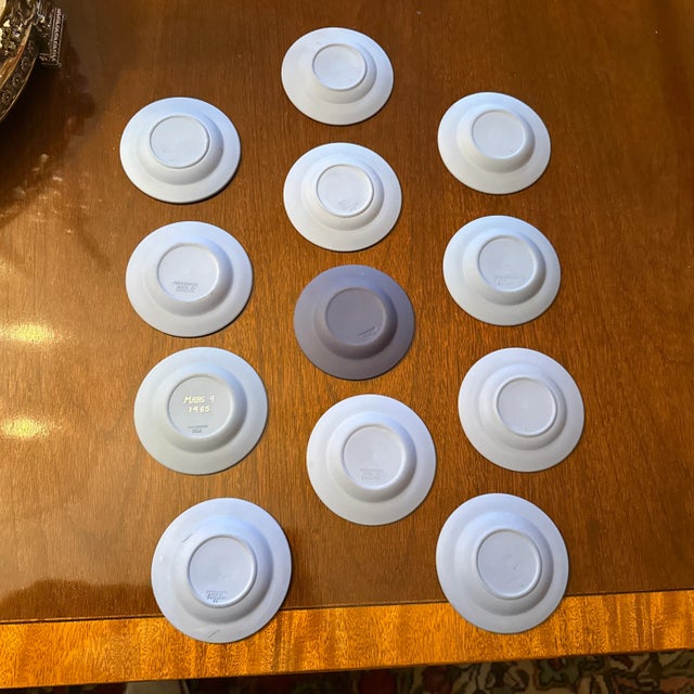 Wonderful collection of 12 Wedgwood blue Jasperware trinket plates. Some featuring seals of the original 13 states and...