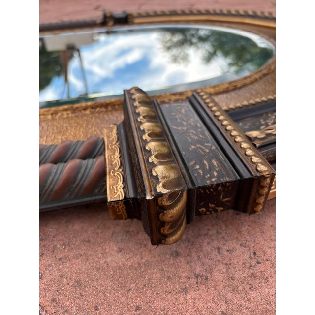 Elegant late 20th century neoclassical mirror featuring a richly detailed architectural frame, beautifully combining...