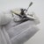 This vintage silver decorative object depicts a detailed canoe rower figurine, crafted as a sports curiosity or cabinet...