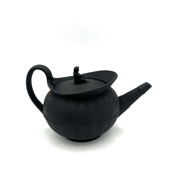 This exquisite antique Wedgwood teapot, crafted in the late 18th century, is made of black basalt, a material long...