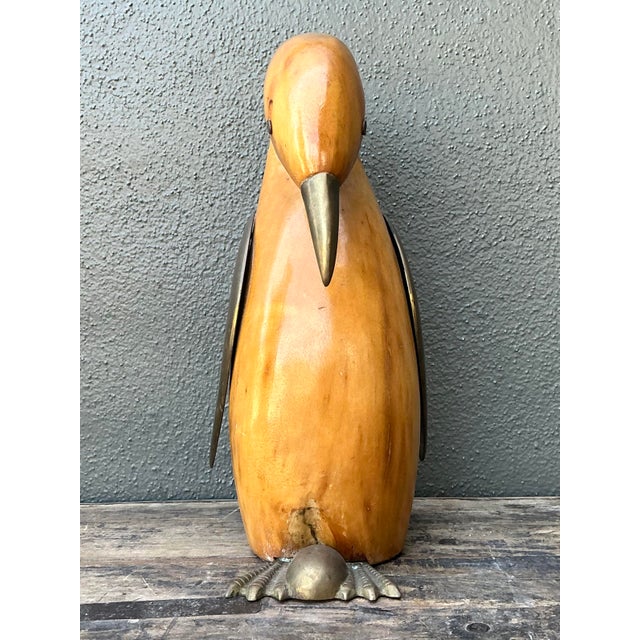 This striking penguin sculpture is a masterful blend of organic warmth and refined metalwork, epitomizing the Mid-Century...