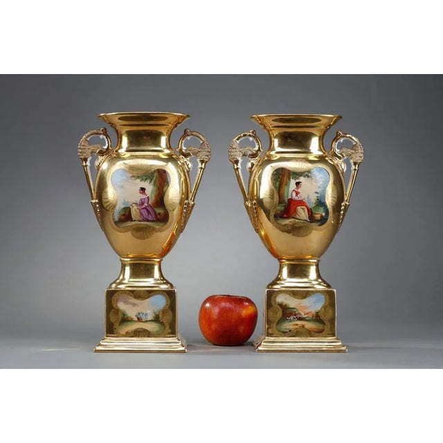 Pair of oratory vases of the Louis-Philippe period in Paris porcelain with golden highlights and polychrome decoration in...