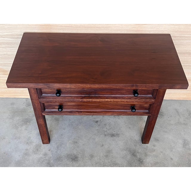 20th century pair of Spanish nightstands with two carved drawer and iron hardware and crest in the low part of the...