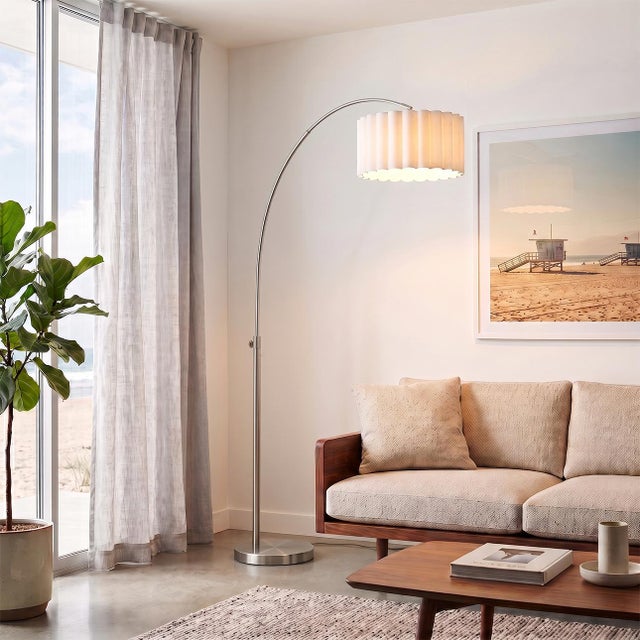 The Scallop Arc Lamp is a Peter Morelli-designed modern arc lamp featuring a satin nickel finish and a durable steel base....