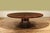 90-inch round flame mahogany dining table. Features a 1.5-inch-thick flame mahogany tabletop supported by an outswept...