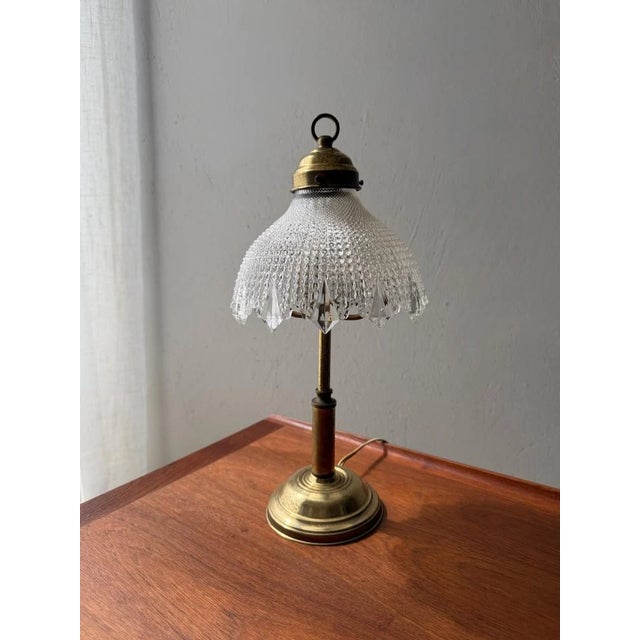 This table lamp is all about the combination of warm brass and distinctive glass. Dating from the 1960s, the lamp features...