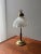 This table lamp is all about the combination of warm brass and distinctive glass. Dating from the 1960s, the lamp features...
