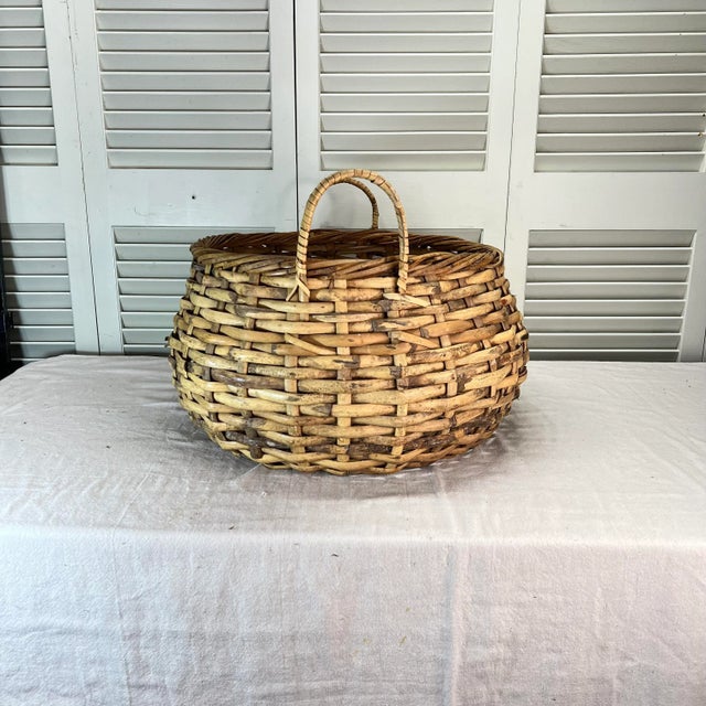 Vintage round split bamboo basket with two handles. Great for kindling or small firewood, extra blankets, children or dog...