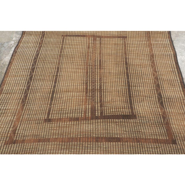 This vintage Moroccan mat is a primitive 5x6 Tuareg work from the nomadic tribe of the same name. Handwoven with reeds and...