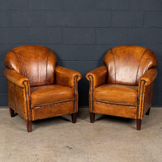 A comfortable and characterful pair of sheepskin leather club chairs, made in Holland in the late 20th century. These...