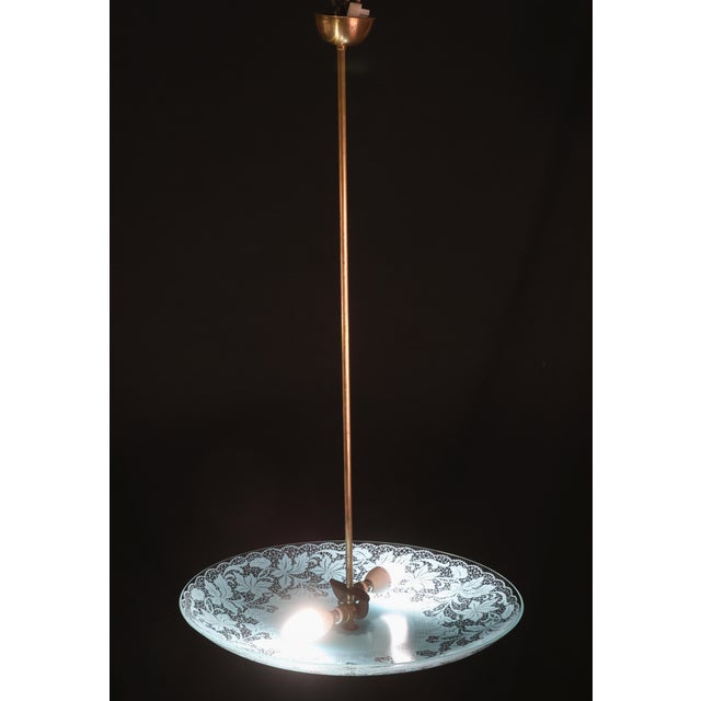 Elegant Italian vintage pendant chandelier featuring a beautifully detailed floral-patterned glass shade suspended from a...