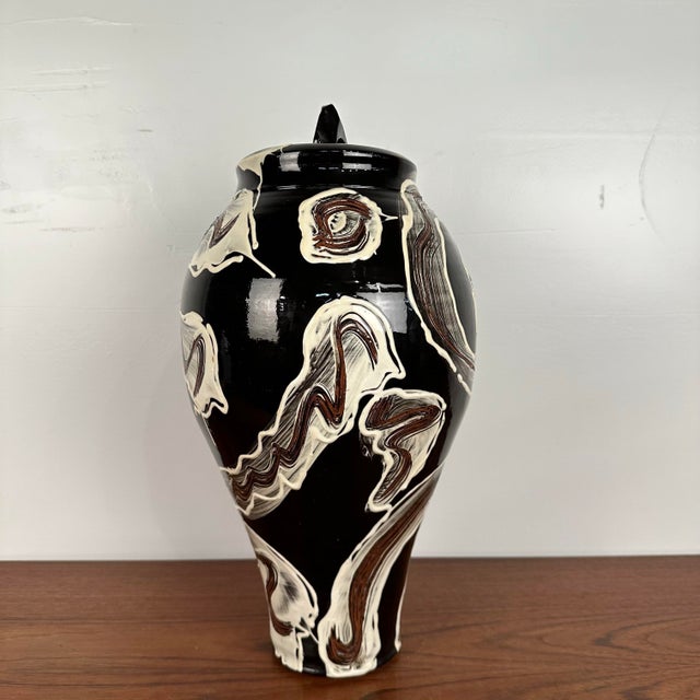 This is a unique piece of Studio Made ceramic hand made by Craig Bird. The piece is a lidded vessel or urn that features...