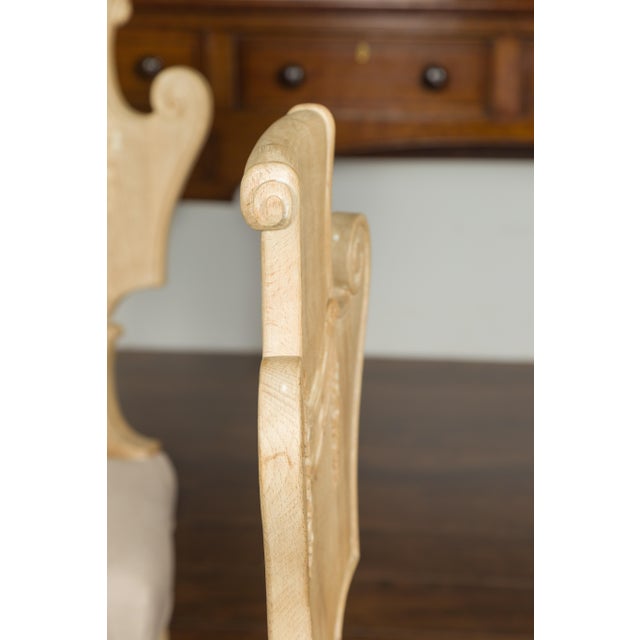 A set of six vintage carved Italian bleached walnut dining room side chairs from the mid-20th century, with scrolling...