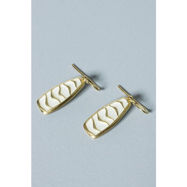Pair of cool silver earrings from David Andersen. The silver is gilded, which makes an elegant contrast with the white...