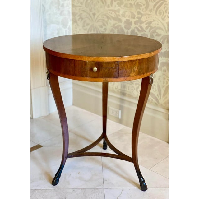 Circa 1810 Walnut Directoire round Table from Lucca, Italy has one drawer and features beautiful pie shaped marquetry. The...