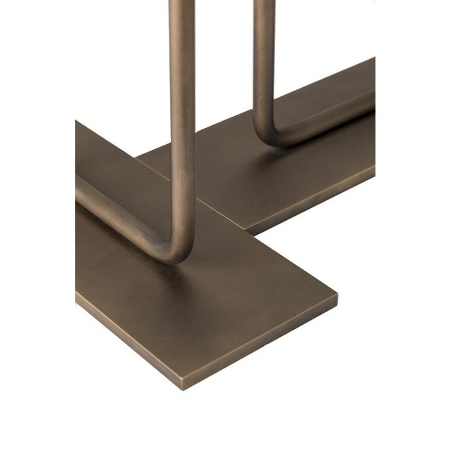Gemini is a two-arm bronze-finished brass sconce made in Italy, characterized by a symmetrical and balanced structure. The...