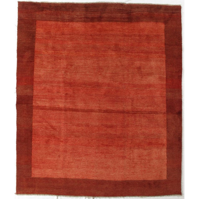 Vintage hand-knotted Persian Gabbeh rug featuring a bold, minimalist field framed by a contrasting border and accented...