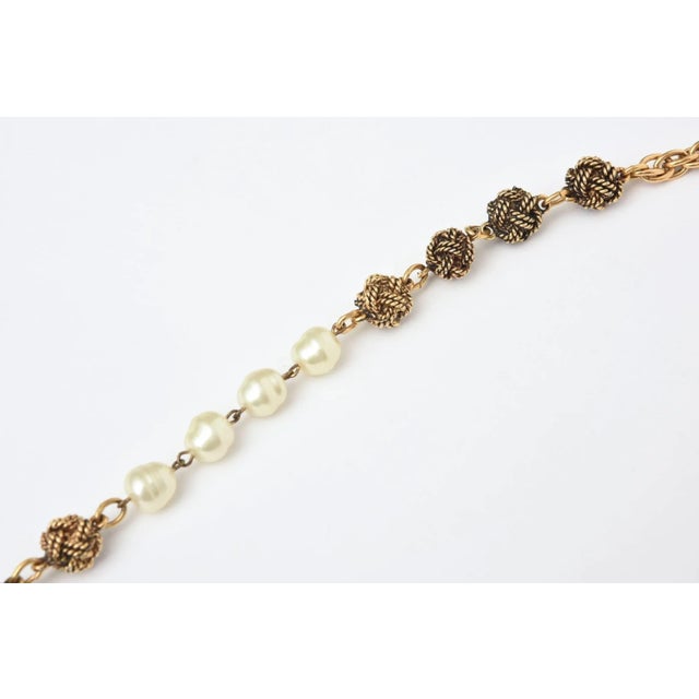 This is part of Chairish’s Costume Jewelry assortment. This classic and forever Chanel long necklace has knots in a darker...