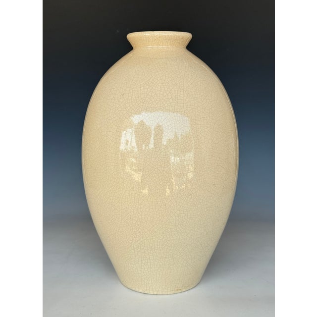 A Tall Robert Lallement French glazed ceramic vase. Color of the vase is cream with crackle glaze design all throughout....