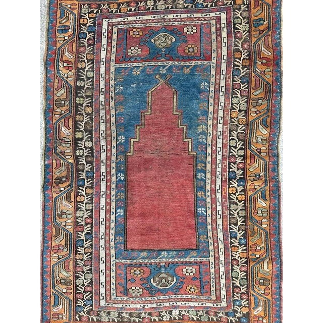 Pretty antique prayer rug from Turkey, with a mihrab design and nice natural colours with a red, blue, orange, green and...