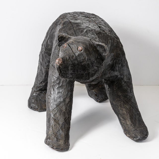 Look who just walked in! This monumental, hand-carved solid hardwood sculpture depicting a powerful black bear in a...