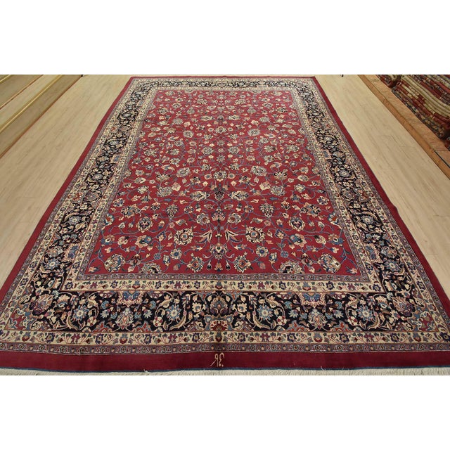 An authentic vintage traditional Mashad rug hand-knotted with fine wool and natural dyes. This rug features an all-over...