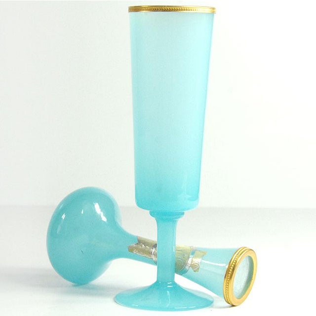 A set of beautiful vases, handcrafted from blue, body-tinted glass. Finished with a gilded metal rim. Designed by Vincenzo...