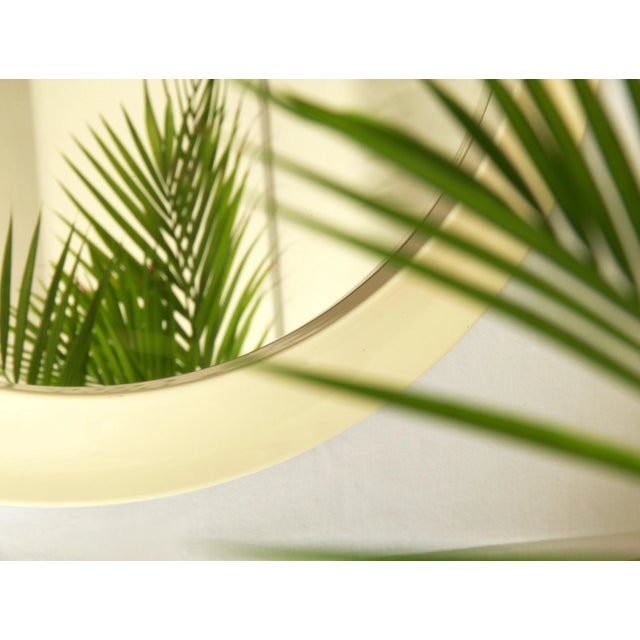 This is an eye-catching mirror realised in Italy in the early 70s. This pop mirror comes in a smooth round shape and the...