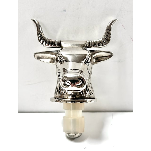 A striking pair of silver-plated bottle stoppers featuring sculptural bull and bear heads, the classic symbols of the...