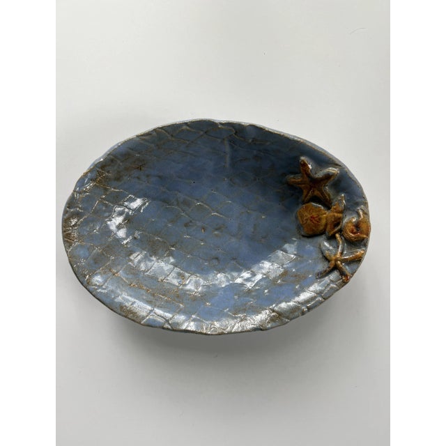 A beautiful Handmade Blue Oval Pottery Serving Bowl With Shell Details. Signed on reverse JHL. This is a great addition to...
