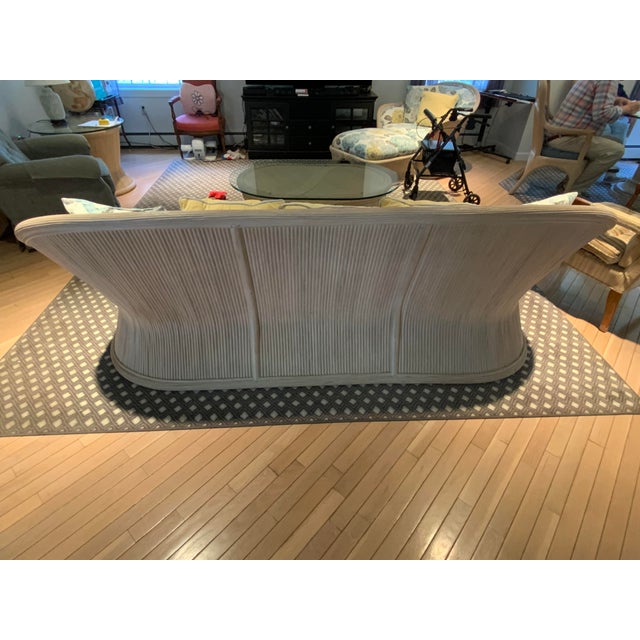 Bamboo sofa with fixed back upholstery , loose seat cushion. No makers mark, but in the style of Ficks Reed.