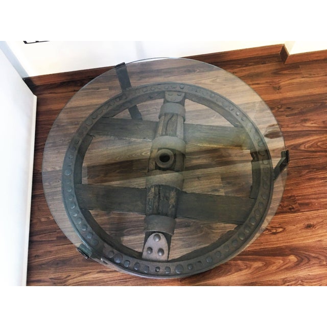 Wooden Wagon Wheel Indutrial Accent Spanish Table With Glass Top For Sale - Image 10 of 11