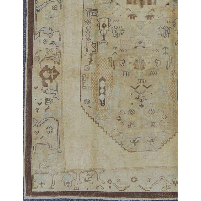 Tribal Vintage Turkish Oushak Rug Featuring Faded Camel, Ivory, and Pale Blue Accents For Sale - Image 3 of 6