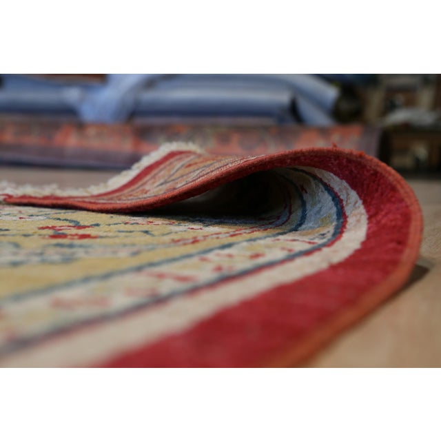 Hand-knotted in wool, this 10 x 14 Oushak rug carpet is a distinguished offering from our contemporary room-size rug...